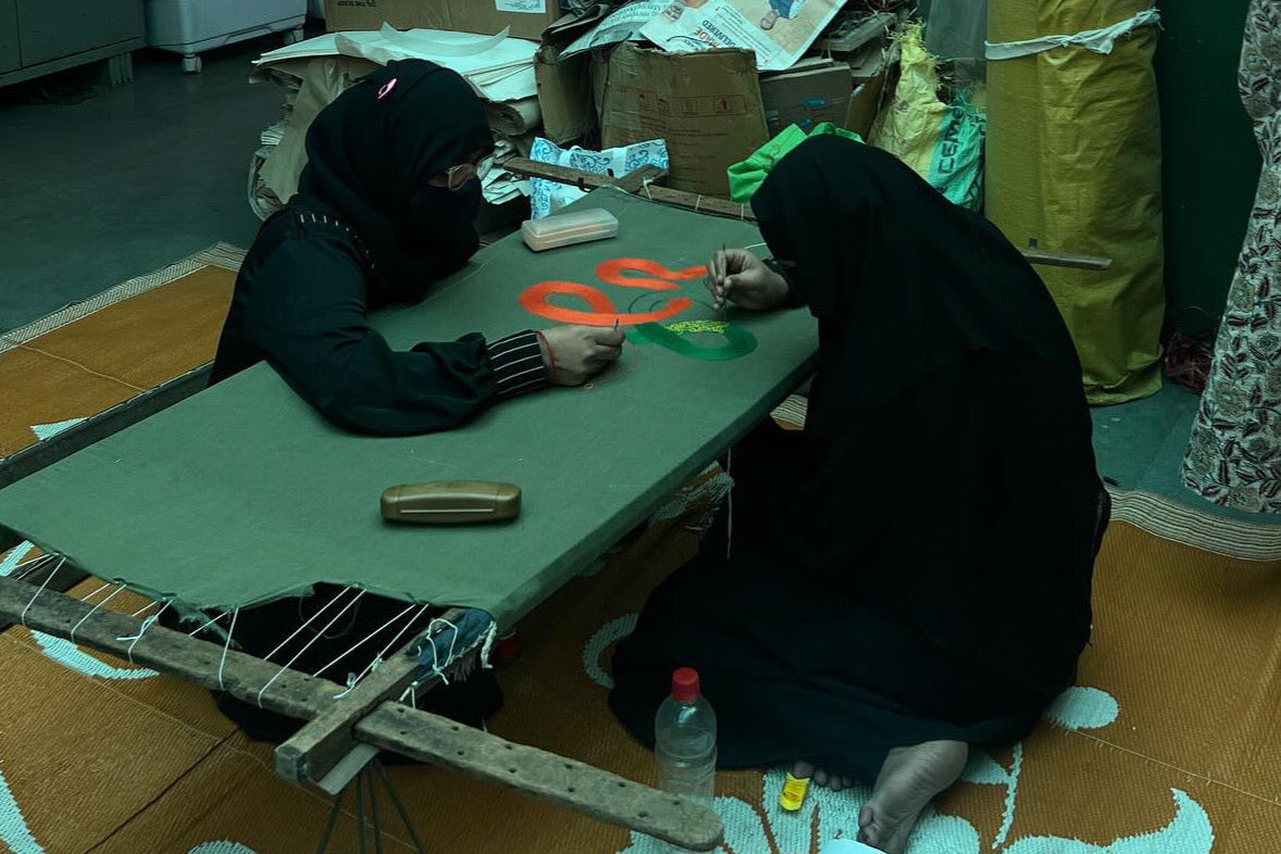 two women working on sari hand embroidery for acid moons studio