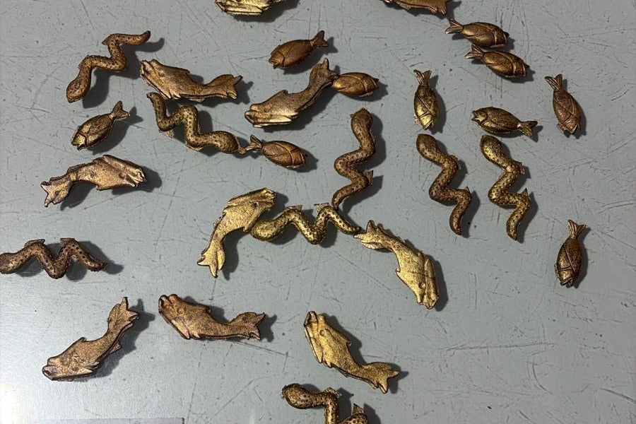 brass figurines as buttons scattered across the table for acid moons